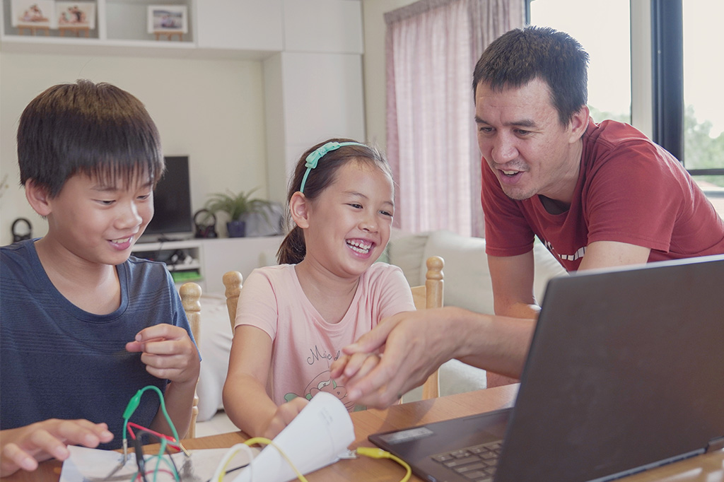 happy children learning at home with parent