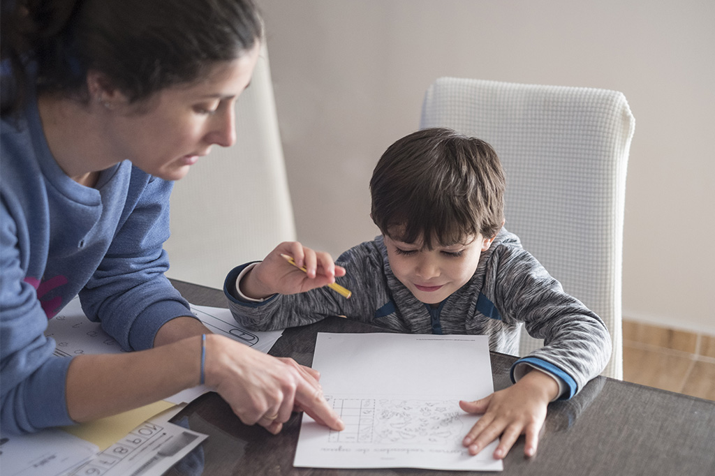 child doing school homework with parent