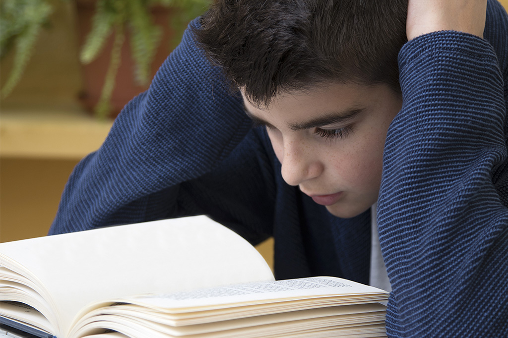 child concentrating to read book