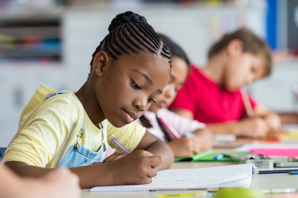 confident child in school classroom