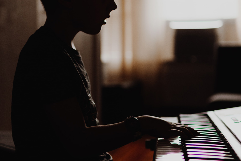 young child playing keyboard