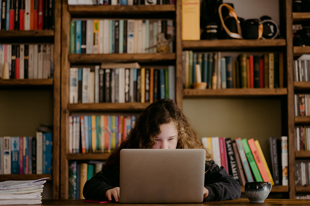 Child reading on a laptop