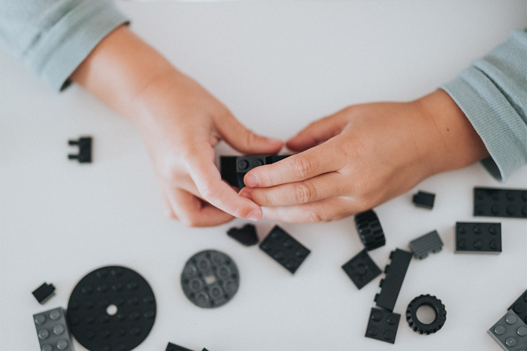 child plays with bricks