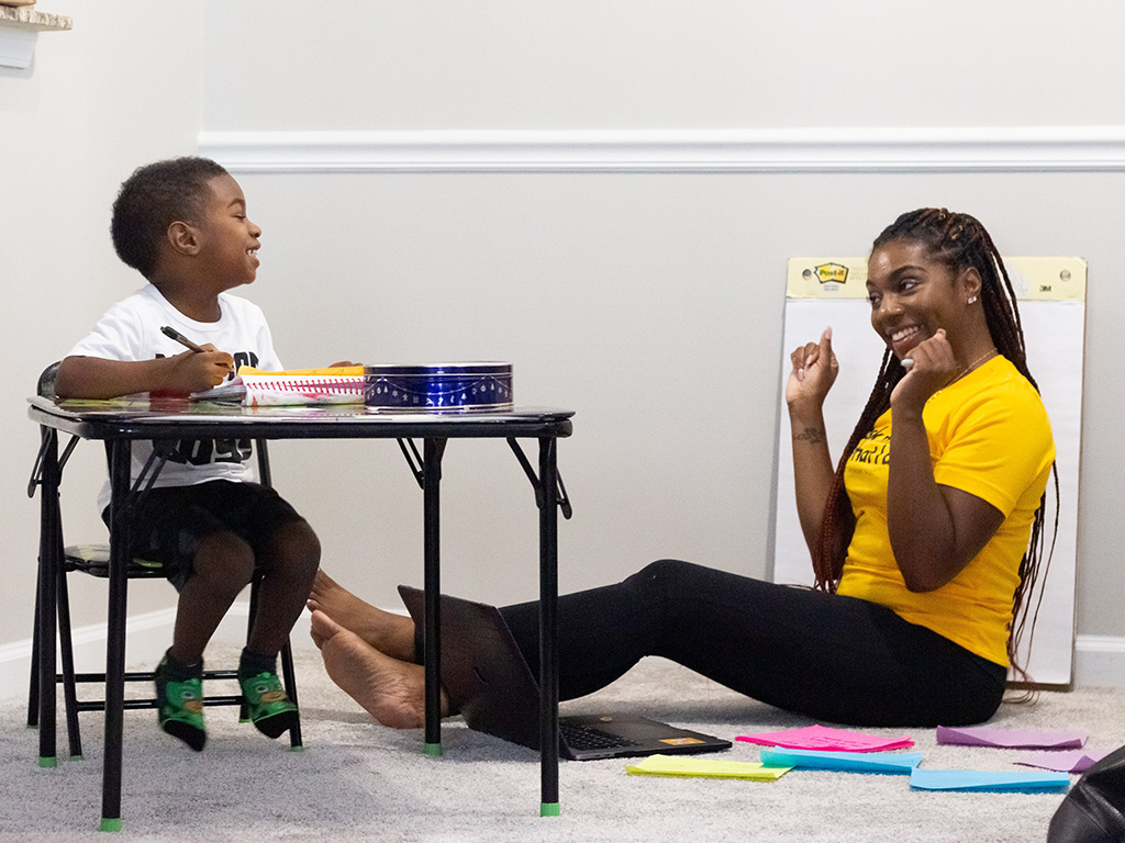 A child and an adult enjoying learning